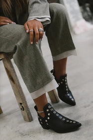 Studded ankle boots worn with wide linen trousers