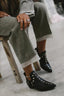 Studded ankle boots worn with wide linen trousers