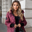 Women's quilted hooded puffer jacket with faux fur trim in burgundy