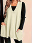 Longline knitted vest worn open over a tee