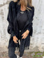 Black fringed cardigan worn with jeans