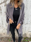 Grey fringed cardigan worn with black jeans