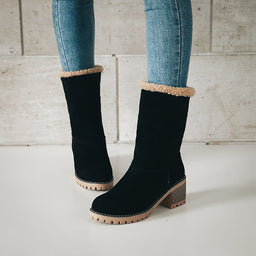 Black shearling cuff ankle boots worn with jeans