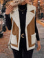 Shearling vest worn over a long sleeve top