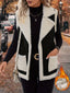 Black shearling vest worn open