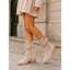 Mid calf slouch boots worn on a pavement