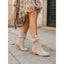 Beige slouch boots worn with a skirt