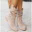 Beige slouch boots worn with a light outfit