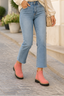 Bright pink ankle boots with black trousers