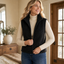 Puffer vest layered under a coat