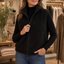 Puffer vest worn over a knit
