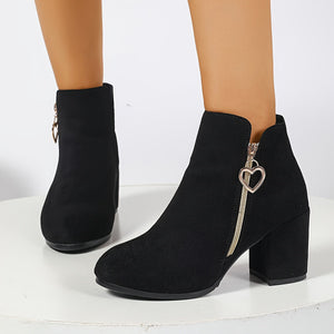 Black suede ankle boots shown from the side