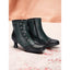 Vintage style ankle boots on a pink background