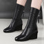 Detail of the ruching on the black wedge boots
