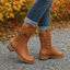 Brown combat boots worn with cuffed jeans